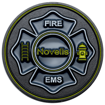 Circular challenge coin featuring a black and neon green Maltese cross with the text Novelis Fire EMS, a ladder icon, and a fire hydrant.