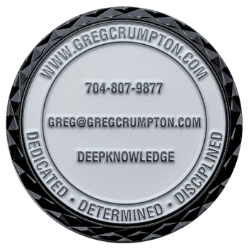 Round challenge coin with black diamond cut edge, white center, and Greg Crumpton contact information.