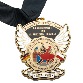 Gold-plated medal with wings, ballroom dancers, and a castle featuring a black neck ribbon.