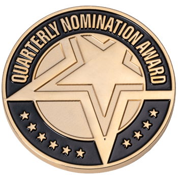 Gold and black circular award coin featuring a large central star and the text Quarterly Nomination Award with small stars on the bottom border.