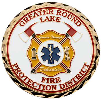 Gold challenge coin with white enamel background, featuring the Greater Round Lake Fire Protection District logo and a blue Star of Life.