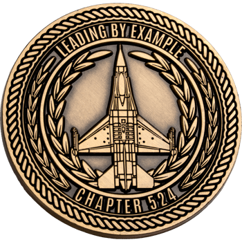 Antique brass challenge coin featuring a fighter jet silhouette, laurel wreath, and the text Chapter 524 Leading By Example.