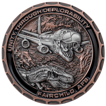Antique copper challenge coin for Fairchild AFB featuring a t-rex and an aircraft with a dinosaur mouth design.