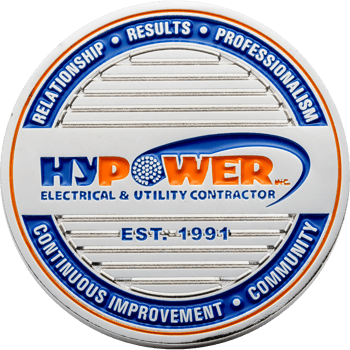Hypower Inc. electrical and utility contractor challenge coin with blue and orange enamel and silver horizontal textured background.