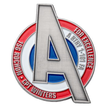Shield-shaped lapel pin featuring a large brushed silver A over red, white, and blue circles with military unit text.