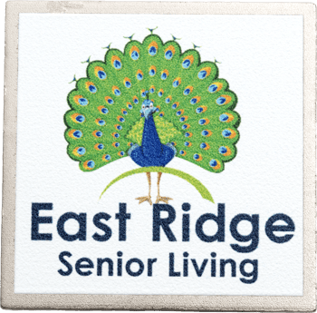 Stone coaster featuring a colorful peacock illustration above the East Ridge Senior Living logo.