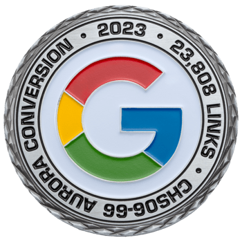 Silver challenge coin with the Google G logo in red, yellow, green, and blue, featuring the text Aurora Conversion 2023 and 23,808 Links.