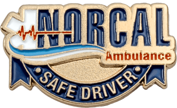 Gold and blue Norcal Ambulance Safe Driver lapel pin with EKG heartbeat line and wave details.