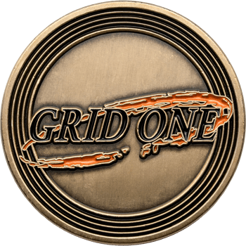 Antiqued bronze challenge coin featuring the Grid One logo with orange and black enamel accents.