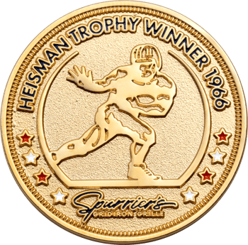 Gold challenge coin featuring a Heisman Trophy Winner 1966 design with a football player silhouette and Spurrier's Gridiron Grille logo.