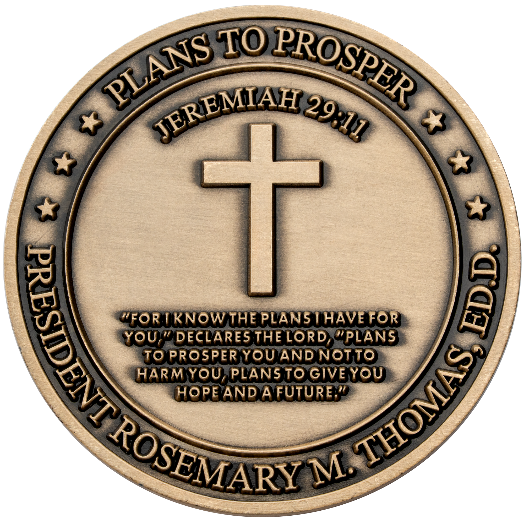 Antiqued bronze challenge coin featuring a central cross, Jeremiah 29:11 scripture, and the name President Rosemary M. Thomas.