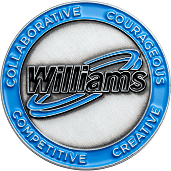 Circular challenge coin with blue border featuring the text William's, Collaborative, Courageous, Creative, and Competitive on a brushed silver background.