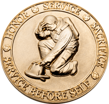 Gold challenge coin featuring a kneeling firefighter in full gear with a helmet, surrounded by the words Honor, Service, Sacrifice, and Service Before Self.
