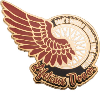 Enamel lapel pin featuring a maroon wing, spoked wheel, and the text Dale's Wheels Through Time Museum Lifetime Donor.