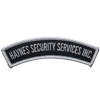 Arched embroidered patch with white text Haynes Security Services Inc. on a black background with a silver border.