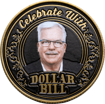 Antique gold challenge coin featuring a man's portrait with 'Celebrate With Dollar Bill' text and ornate scrollwork border on a black background.
