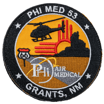 Circular embroidered patch for PHI Air Medical Grants NM featuring a helicopter, Route 66 sign, and Zia sun symbol.