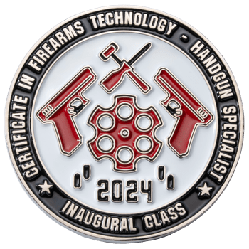 Circular challenge coin featuring red handguns, tools, and a revolver cylinder with 'Certificate in Firearms Technology - Handgun Specialist' text.