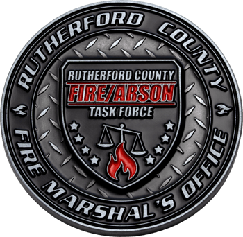 Circular challenge coin for the Rutherford County Fire/Arson Task Force featuring a diamond plate background, a central shield with scales of justice, and a red