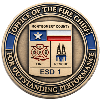 Antiqued gold challenge coin for Montgomery County ESD 1 Office of the Fire Chief featuring a Texas flag, fire department logo, and rescue emblem.