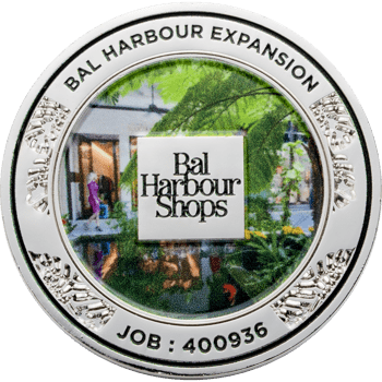Silver challenge coin featuring the Bal Harbour Shops logo and a colorful garden scene with a silver border.