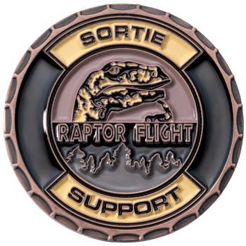 Circular challenge coin featuring a Gila monster head, pine tree silhouettes, and the text Sortie Raptor Flight Support in copper and enamel.