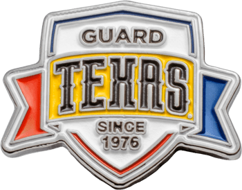 Shield-shaped lapel pin featuring Texas Guard text in black and white on a yellow, red, and blue background.