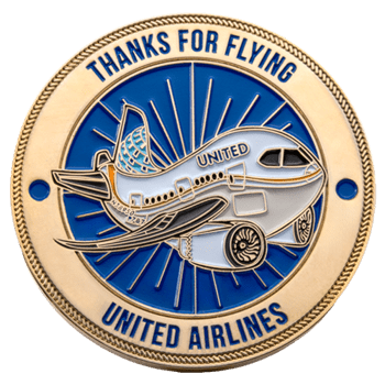 Circular gold challenge coin featuring a United Airlines jet on a blue background with the text Thanks for Flying.