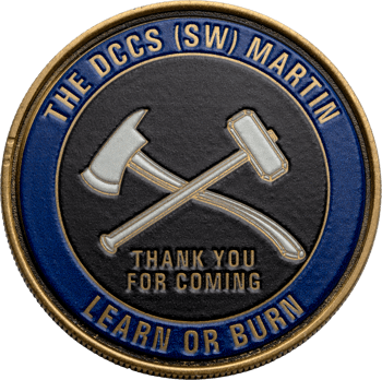 Circular challenge coin featuring crossed axe and sledgehammer, with a blue outer ring reading 'The DCCS (SW) Martin' and 'Learn or Burn'.