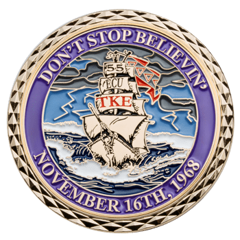Gold challenge coin featuring a skeleton pirate ship on rough seas with the text ECU and TKE on the sails and a purple border.