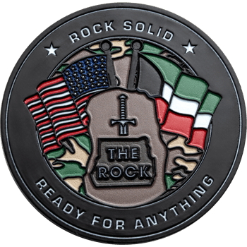 Black challenge coin featuring American and Italian flags, a sword emblem on a rock, and the text Rock Solid Ready For Anything.