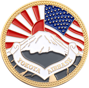 Yokota Air Base challenge coin featuring Mount Fuji, the US flag, and a rising sun background with a rope edge.