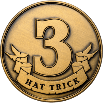 Antiqued gold challenge coin featuring a large number 3 and a banner with the text Hat Trick.