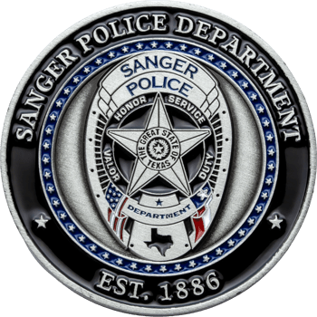 Silver and black Sanger Police Department challenge coin featuring a central badge emblem with a five-point star, Texas state seal, and American flag accents.