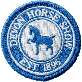 Circular embroidered patch for the Devon Horse Show featuring a blue horse silhouette and established date 1896.