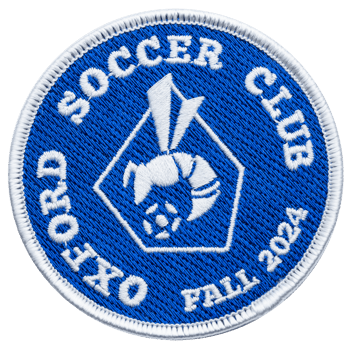 Circular embroidered patch for Oxford Soccer Club Fall 2024 featuring a white hornet and soccer ball on a blue background with a white border.