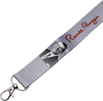 Grey fabric lanyard featuring a black and white portrait and red signature script of Ronald Reagan with a metal lobster claw clip.