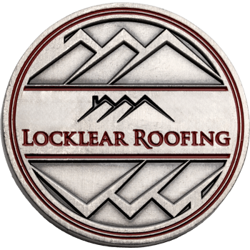 Antiqued silver challenge coin featuring the Locklear Roofing logo with mountain and roof line graphics.