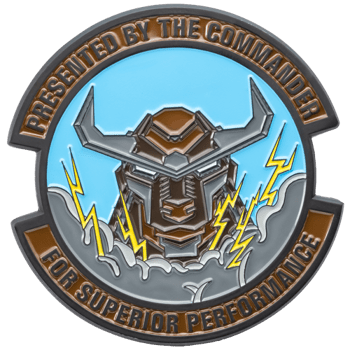 Circular challenge coin featuring a robotic bull head with lightning bolts and the text Presented By The Commander for Superior Performance.
