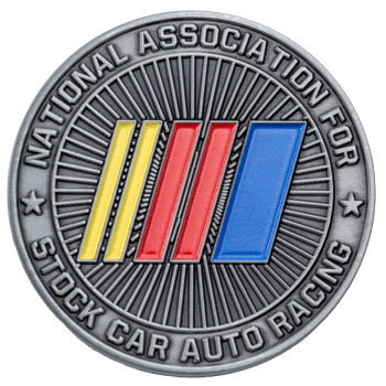 Antique silver challenge coin for the National Association For Stock Car Auto Racing featuring yellow, red, and blue stripes on a sunburst background.