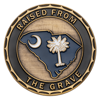 Antiqued gold challenge coin featuring the South Carolina state outline with a crescent moon and palmetto tree, bordered by the text Raised From The Grave.