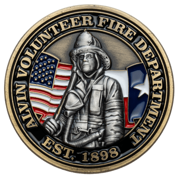 Bronze challenge coin for Alvin Volunteer Fire Department featuring a firefighter in gear with the American and Texas flags in the background.
