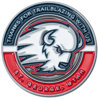 Circular metal challenge coin featuring a white buffalo head design with red, white, and blue enamel and the text St. George, Utah.