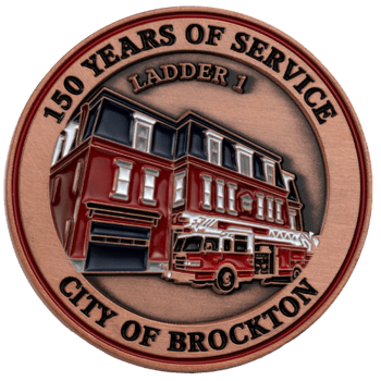 Antiqued copper challenge coin featuring a red firehouse and fire truck with text 150 Years of Service, Ladder 1, City of Brockton.