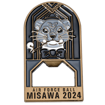 Enamel bottle opener featuring an otter in a tuxedo and hat with 'Misawa Air Force Ball 2024' text on a gold and black art deco background.