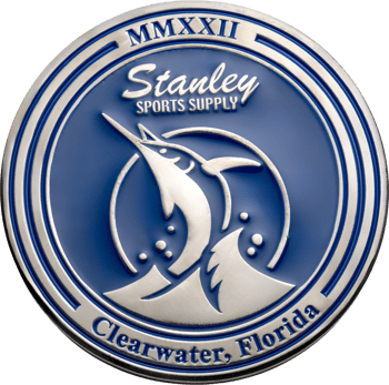 A silver and blue challenge coin featuring Stanley Sports Supply, a marlin, and Clearwater, Florida text.